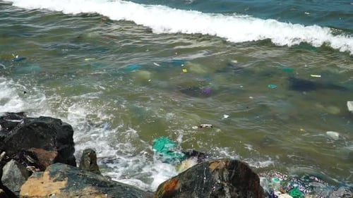 Plastic pollution trash in ocean with different kinds of garbage - plastic bottles, bags, wastes flo