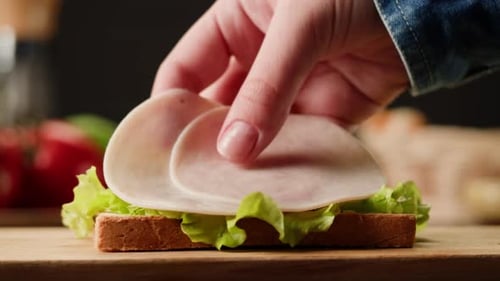 Preparing a Delicious Sandwich with Meat and Cheese