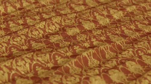 Seamless Flowing Fabric Texture with Golden Floral Pattern
