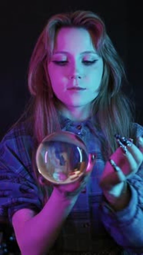 A Young Woman Does Contact Juggling with a Crystal Ball