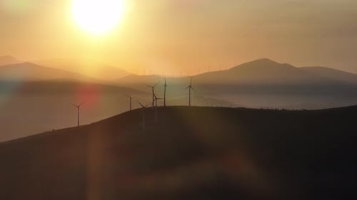Wind Turbines Harnessing Energy at Golden Sunrise