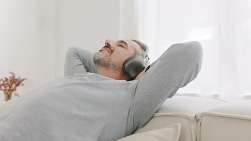Man Relaxing on Couch with Wireless Headphones