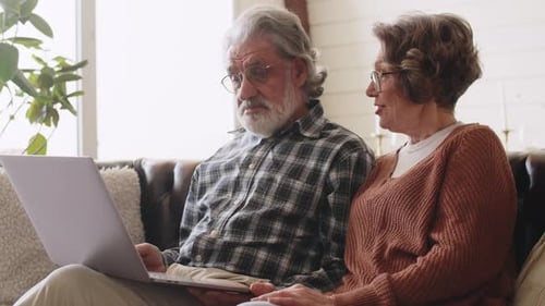 Senior Couple Using Laptop at Home Together