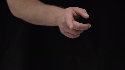 Hand Pointing and Rotating against Black Background