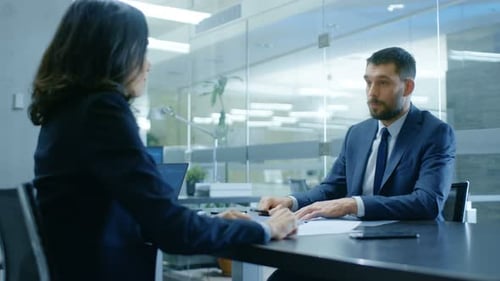 Business Professionals Signing Documents and Shaking Hands