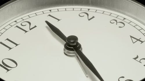 The alarm clock on a black background, in the style of time-lapse video.