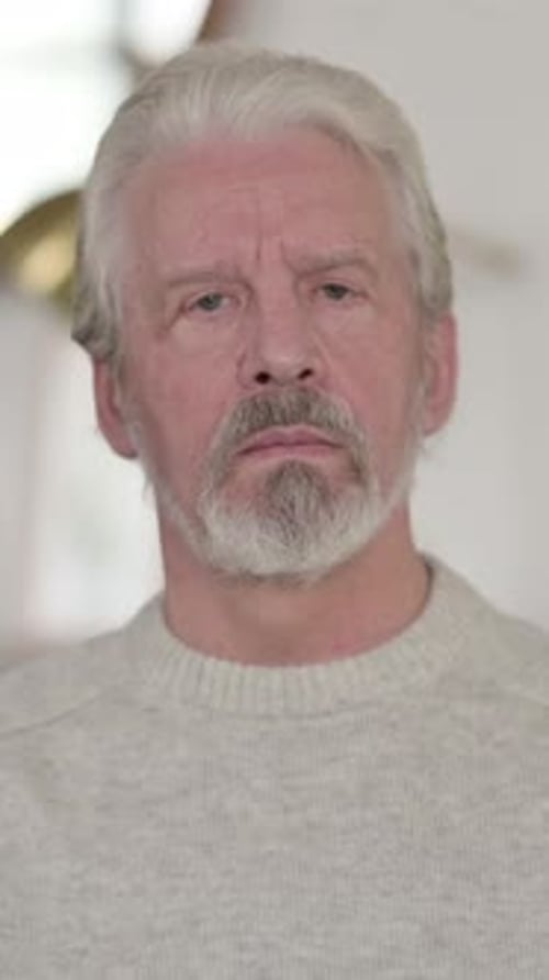 Senior Man Looking Directly at Camera Indoors
