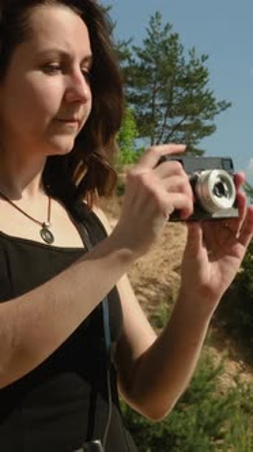 Woman Taking Pictures with Vintage Camera Outdoors