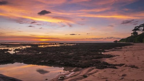 Time lapse: sunset colorful sky on sea, tropical coral beach, dramatic clouds, t