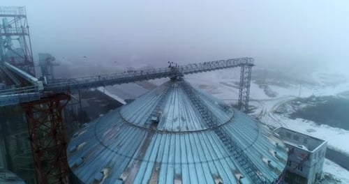 Grain Elevator in Snowy Rural Winter Landscape