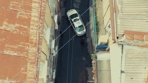 A Highaltitude Perspective Showcasing an Urban Street Scene Featuring a Parked Police Car