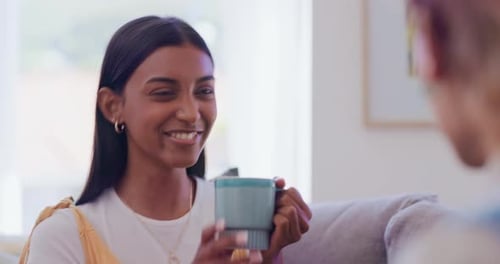 Friends Laughing Together Indoors While Drinking Coffee
