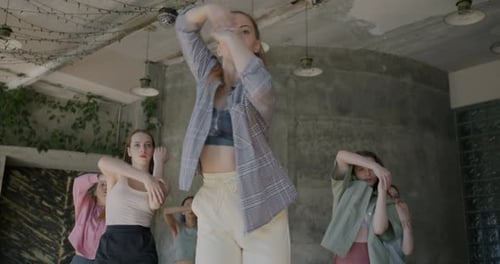 Group of Young Women Dancing Enjoying Music and Creative Occupation in Arts Studio