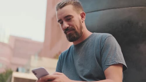 Man Using Mobile Phone in Urban Setting