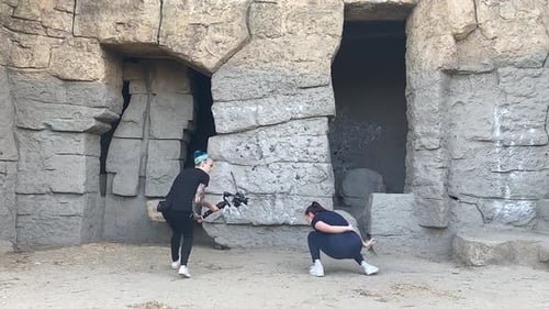 Woman Dancing as Friend Records in Urban Setting