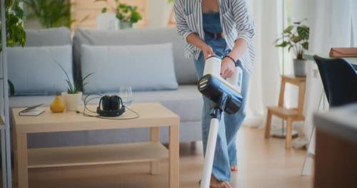 Woman Vacuuming in a Bright Modern Living Room