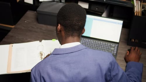 Adult working at a Desk in Dark Office