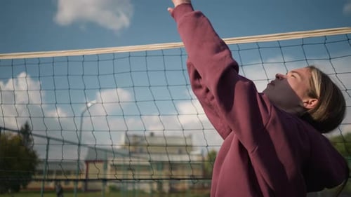 Young Adult Woman Plays Volleyball