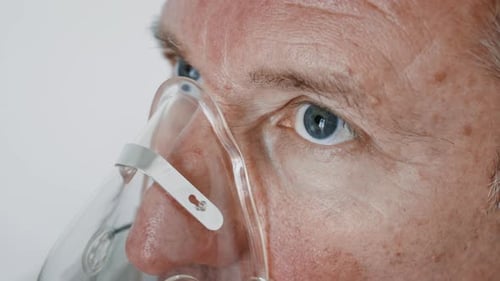 Closeup View of a Person Wearing an Oxygen Mask in a Medical Setting During a Health Examination or