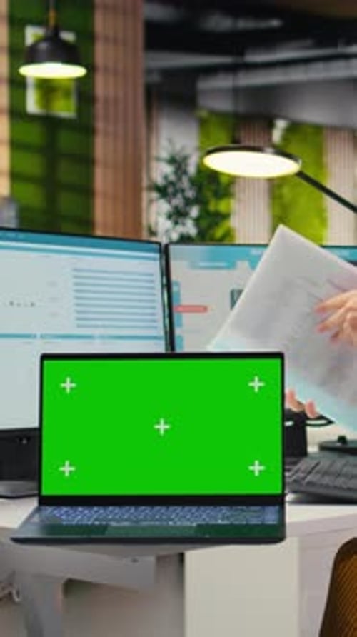 Vertical Video Corporate Staff Uses Dual Monitors to Analyze Charts with Mockup on Laptop
