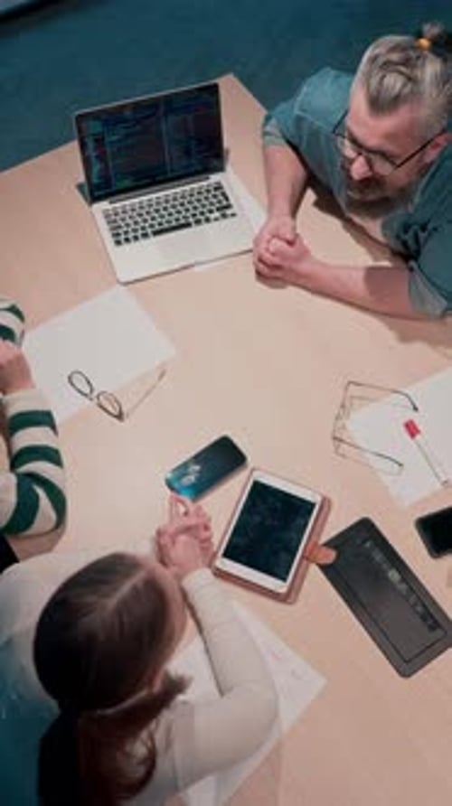 In a Sleek Glass Office Space a Team of Business Professionals Engage in Lively Discussions and