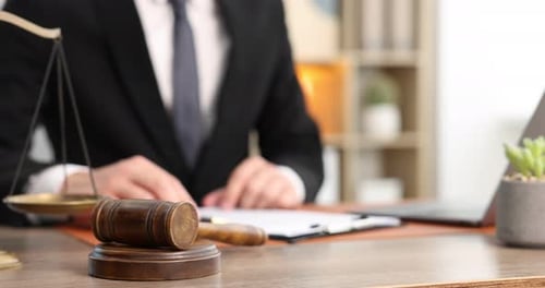 Attorney Reviews Legal Documents at Office Desk