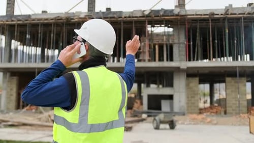 Architect engineer man at construction site call with telephone planning, communication