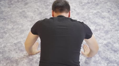Man doing push-ups at home.