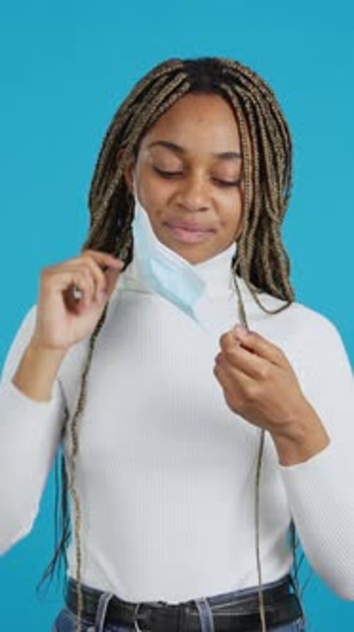 African Woman Looking at Camera Using a Protective Face Mask