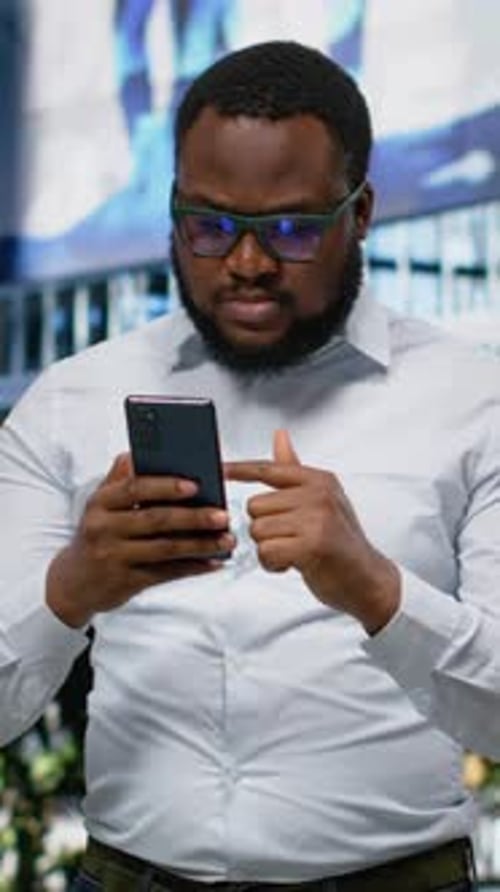 Vertical Video African American Male Scrolling Websites and Mobile Apps on City Street