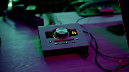 professional recording studio sound engineer finger adjusts sound volume level on mixer console
