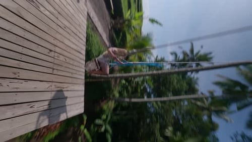 Woman Enjoys Rope Swing in Tropical Paradise