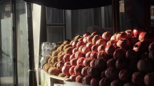 Pomegranates and Coconuts are on the Counter of the Farmer's Market