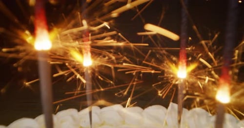 Festive Sparklers Burning on Birthday Cake