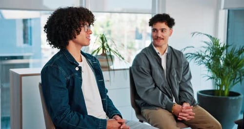 Young Adults Talking in a Modern Workplace Setting