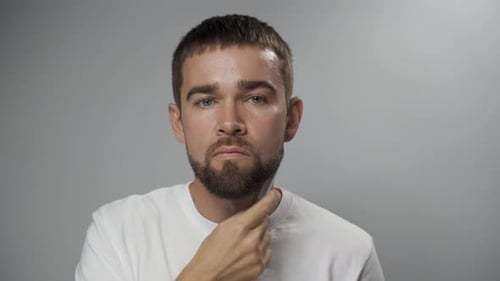 Man Styling Beard with White Comb