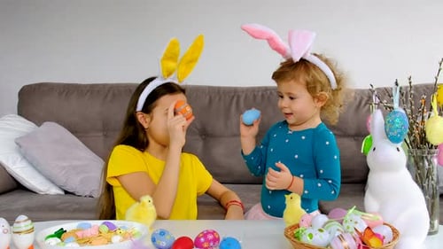Girls with Bunny Ears Play with Easter Eggs