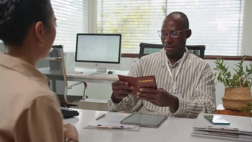 Female Client Giving Passport to Bank Manager when Taking out Loan