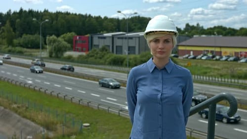 A professional woman engineer wearing a helmet to selt an example to worker of safety in the work pl