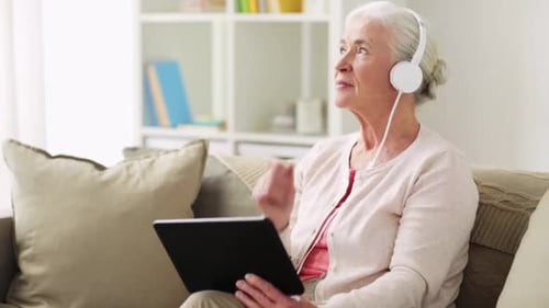 Senior Woman Enjoying Music with Tablet and Headphones
