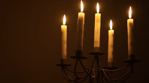 Candles Burning in Candelabra Lighting the Darkness