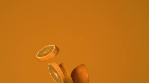 Highspeed camera shot of an orange flying through the frame in 1000 fps with orange background
