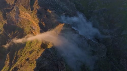 Majestic aerial view of mountain peaks and mist in a serene landscape