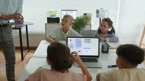 Elementary School Kids Learning New Topic with Teacher at IT Class