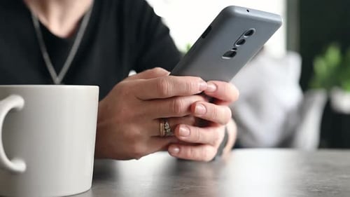 Girl Using a Smartphone in the Kitchen