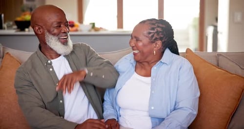 Senior Couple Laughing and Relaxing at Home
