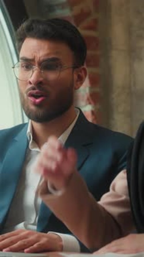Frustrated Man and Woman Arguing in an Office