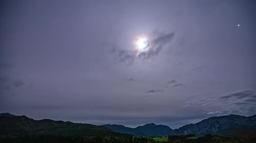 Central Alps, Austria, Europe - Sunlight Filtering Through the Gray Sky Above the Mountain - Timelap