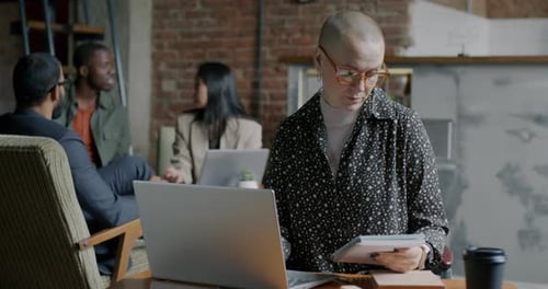 Young Woman Using Laptop Typing Concentrated on Computer in Modern Coworking Space