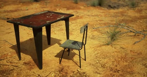 Abandoned Table and Chair Sit Under the Vast Dry Landscape